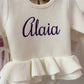 Newborn wearing personalized Warm White Ballerina romper with matching bow and booties