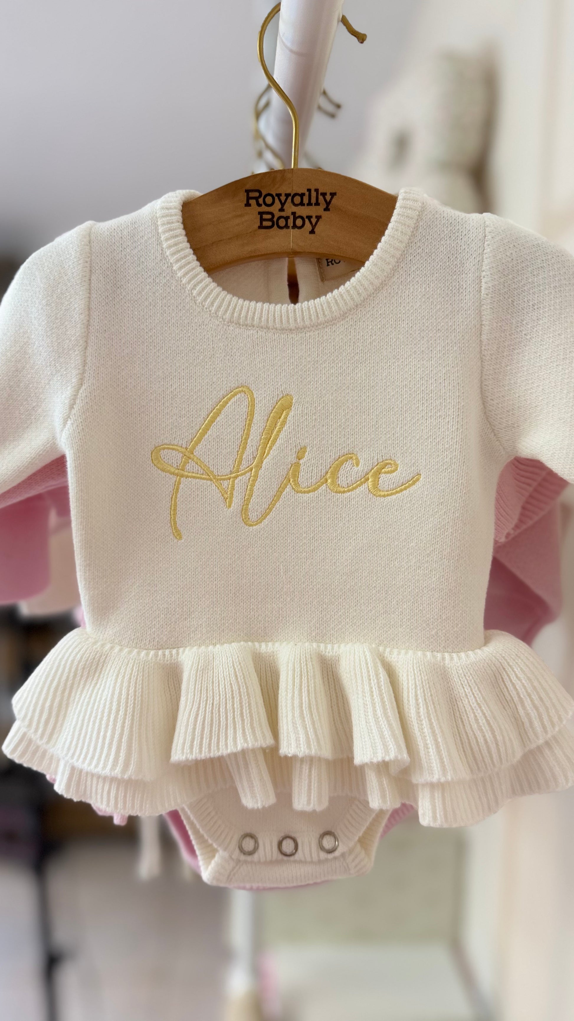 Newborn wearing personalized Warm White Ballerina romper, close detail