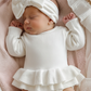 Newborn wearing personalized warm white Ballerina romper with matching bow and booties