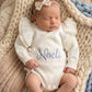 Newborn wearing personalized warm white Butterfly romper with embroidery, lying on knit blanket