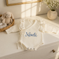 Personalized warm white Butterfly romper with embroidery, styled on dresser