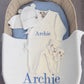 Warm White Kimono long romper set arranged with a bear-ear hat, classic booties and embroidered knit blanket for baby's first Christmas.