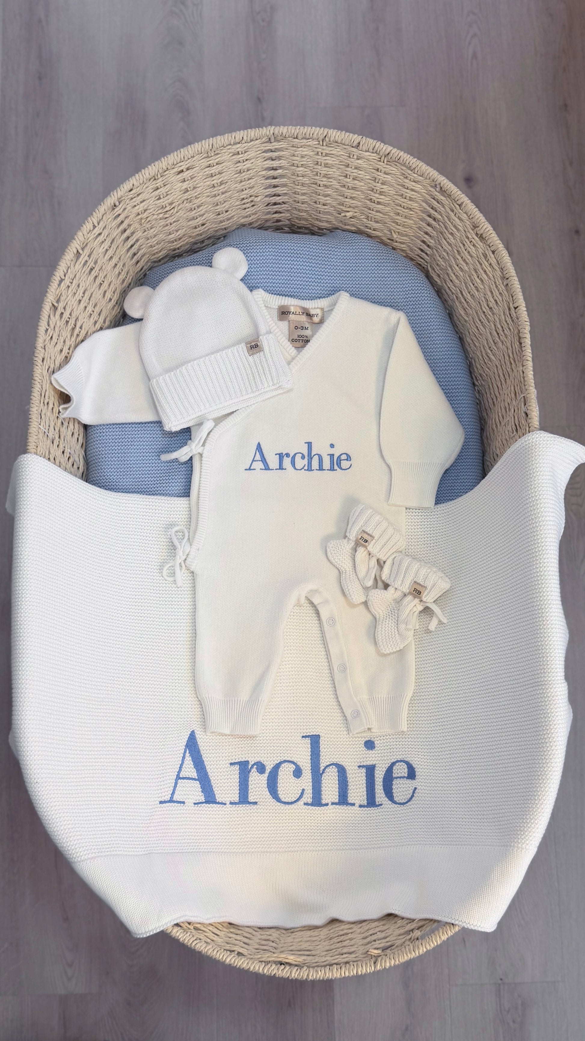 Warm White Kimono long romper set arranged with a bear-ear hat, classic booties and embroidered knit blanket for baby's first Christmas.