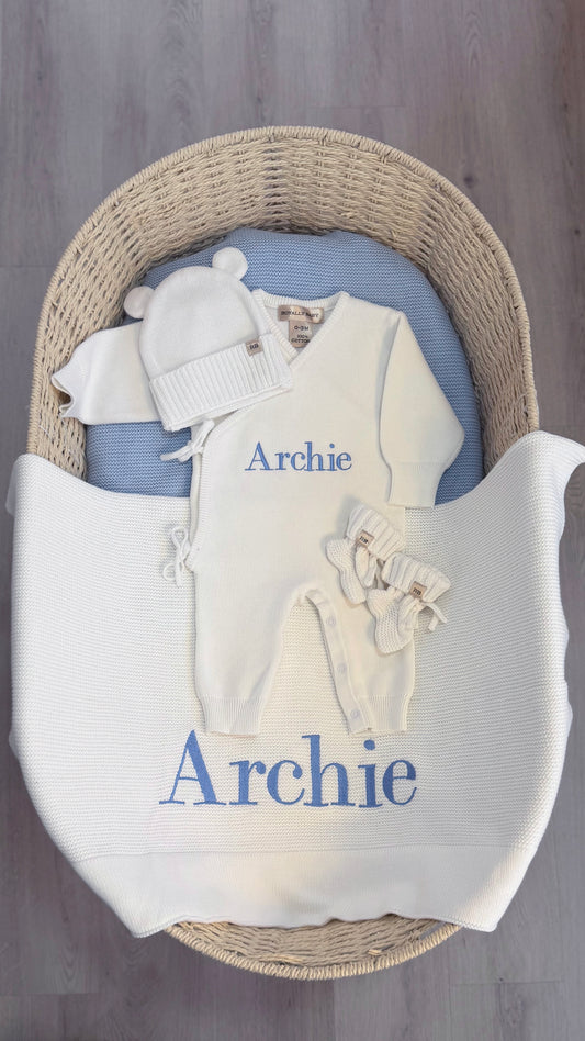Warm White Kimono long romper set arranged with a bear-ear hat, classic booties and embroidered knit blanket for baby's first Christmas.