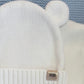 Close-up of the Warm White bear-ear knit hat included with the personalized newborn Kimono romper set