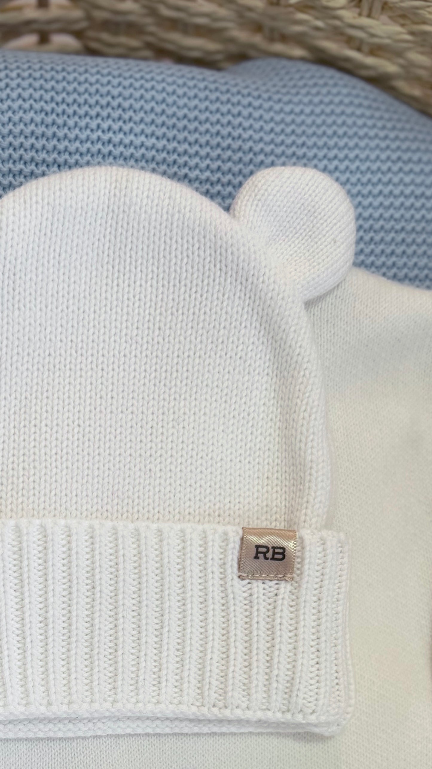 Close-up of the Warm White bear-ear knit hat included with the personalized newborn Kimono romper set
