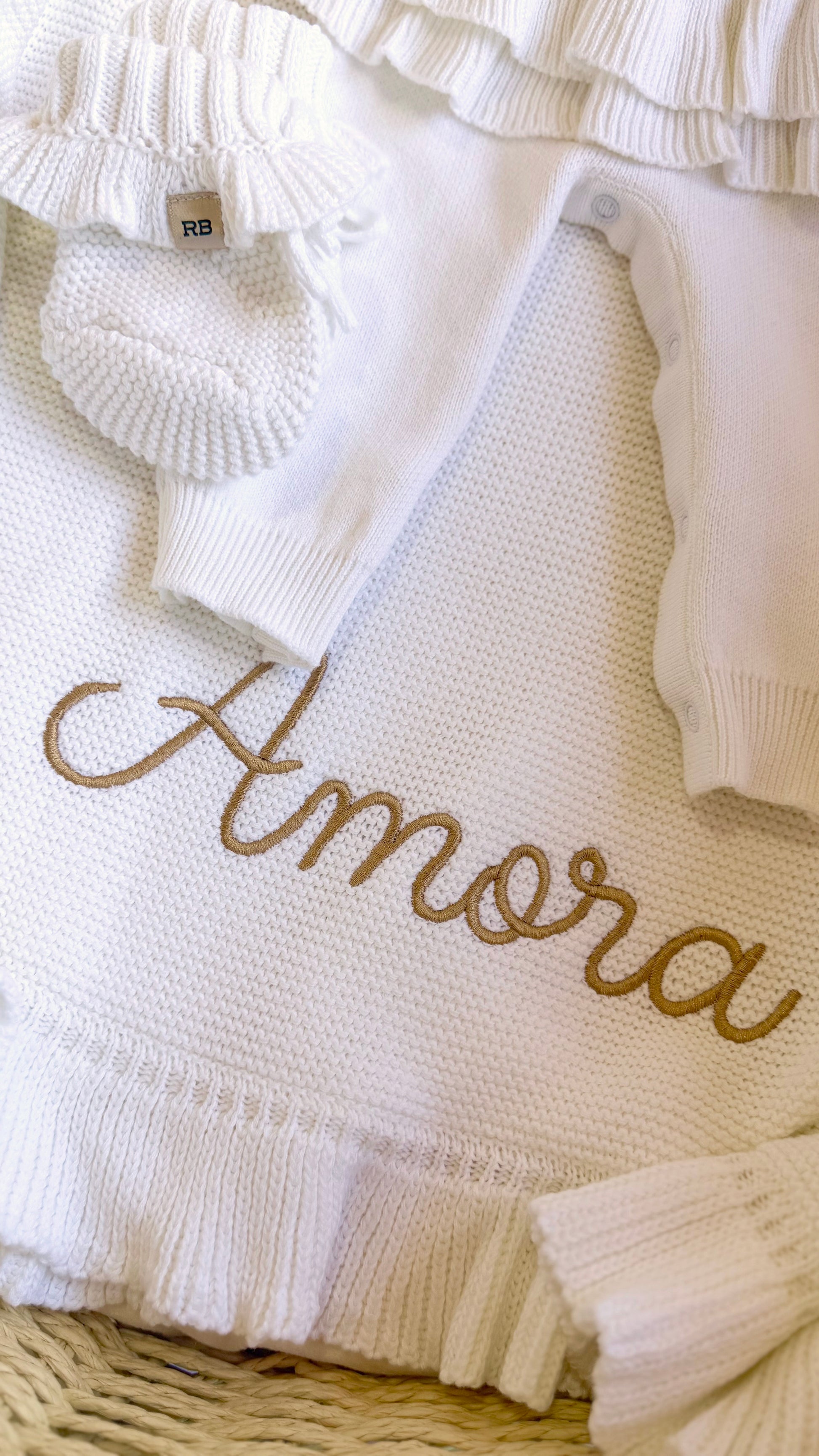Personalized Warm White ruffle knit blanket embroidered with Amora in golden tan thread