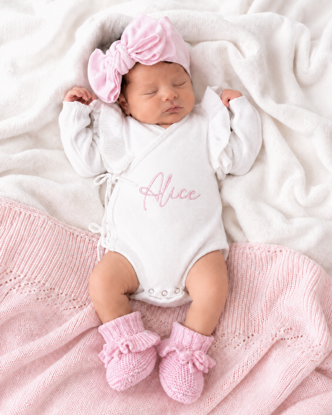 Newborn wearing personalized warm white Butterfly romper with petal pink bow and booties