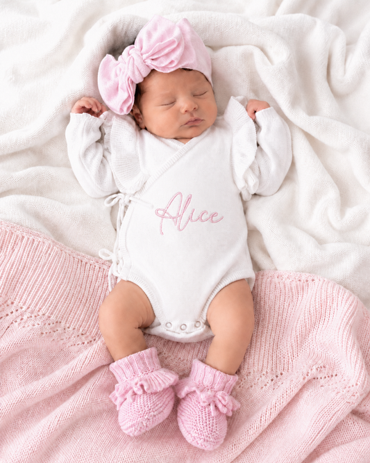 Newborn wearing personalized warm white Butterfly romper with petal pink bow and booties