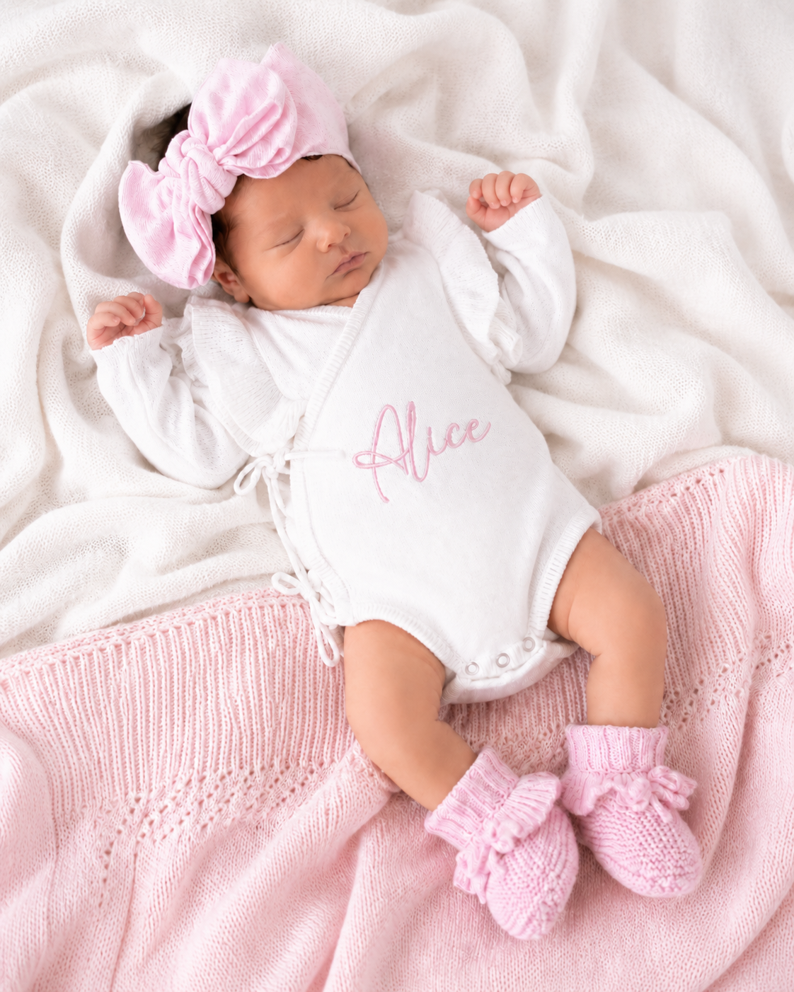 Newborn wearing personalized warm white Butterfly romper with petal pink bow and booties