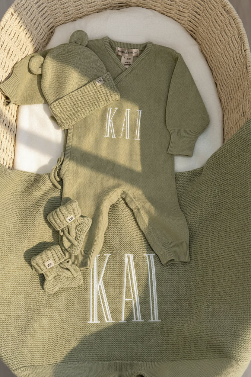 Personalized Soft Sage kimono romper set displayed with the matching Classic Knit Blanket