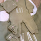 Personalized Soft Sage newborn romper set arranged with matching knit accessories